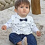 toddler, child, sand, outdoor, playground, rope, denim_pants, white_shirt, bow_tie, sitting, cute, curious, face, skin, hair, footwear, casual_clothing, daylight, young_child, expression