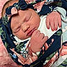 baby, blanket, bow, child, close_up, cozy, face, floral, fuzzy_blanket, hands, headband, indoors, infant, newborn, peaceful, pink, portrait, resting, sleeping, swaddled