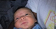 Kamari is registered to the contest to win money with this photo: baby, newborn, blanket, adult, face, portrait, indoor, cozy, sleepwear, child, person, infant, closeup, family, comfort, toddler, cuddle, expression, human, rest
