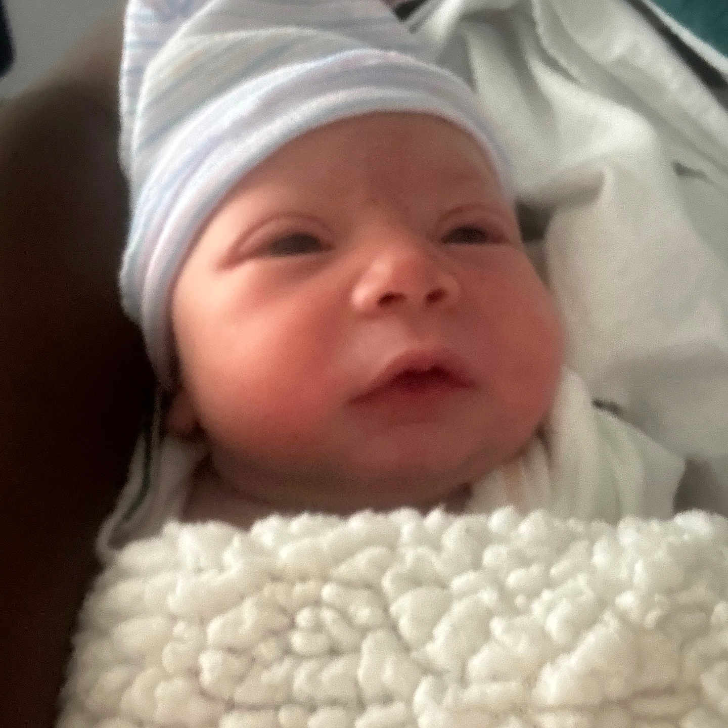 Kamari is registered to the contest to win money with this photo: newborn, baby, blanket, hat, face, person, infant, sleepwear, soft, cute, cozy, wrapped, indoors, portrait, skin, expression, headgear, child, resting, warm