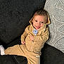 baby, casual, child, clothing, couch, fabric, happy, indoor, infant, nike, pacifier, pillow, portrait, relaxed, seated, smiling, socks, tracksuit, young_child, zipper