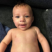 Gianni is registered to the contest to win money with this photo: baby, child, smiling, face, skin, blue_eyes, curl, bare_chest, lying_down, infant, young, cute, portrait, expression, happy, human, indoors, soft_light, closeup, background