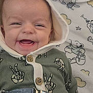 Sonnie joined the competition — help win amazing prizes! baby, smile, hood, clothing, peace_sign, button, blanket, cartoon, bear, cloud, happy, face, infant, child, cute, lying_down, fabric, pattern, comfort, indoors