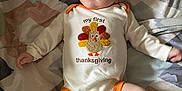 Damion joined the competition — help win amazing prizes! baby, infant, onesie, thanksgiving, turkey, blanket, pattern, sock, clothing, cute, child, face, expression, lying_down, indoors, soft, cozy, person, newborn, holiday