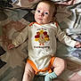 baby, infant, onesie, thanksgiving, turkey, blanket, pattern, sock, clothing, cute, child, face, expression, lying_down, indoors, soft, cozy, person, newborn, holiday