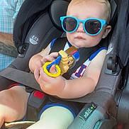 Harden joined the competition — help win amazing prizes! baby, child, car_seat, sunglasses, toy, blue_sunglasses, car_interior, child_safety, seatbelt, infant, person, tattoo, adult, clothing, summer_outfit, window, light, seat, portrait, cute