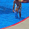 child, adult, pool, water, swimming, summer, outdoor, family, parent, toddler, man, swimwear, tattoo, playground, slide, fun, sunny, daytime, holding_hands, splashing