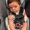 baby, infant, car_seat, child, harness, seatbelt, straps, pink_clothing, hand, face, hair, serious_expression, skin, fingers, sitting, safety, child_seat, closeup, indoors, person