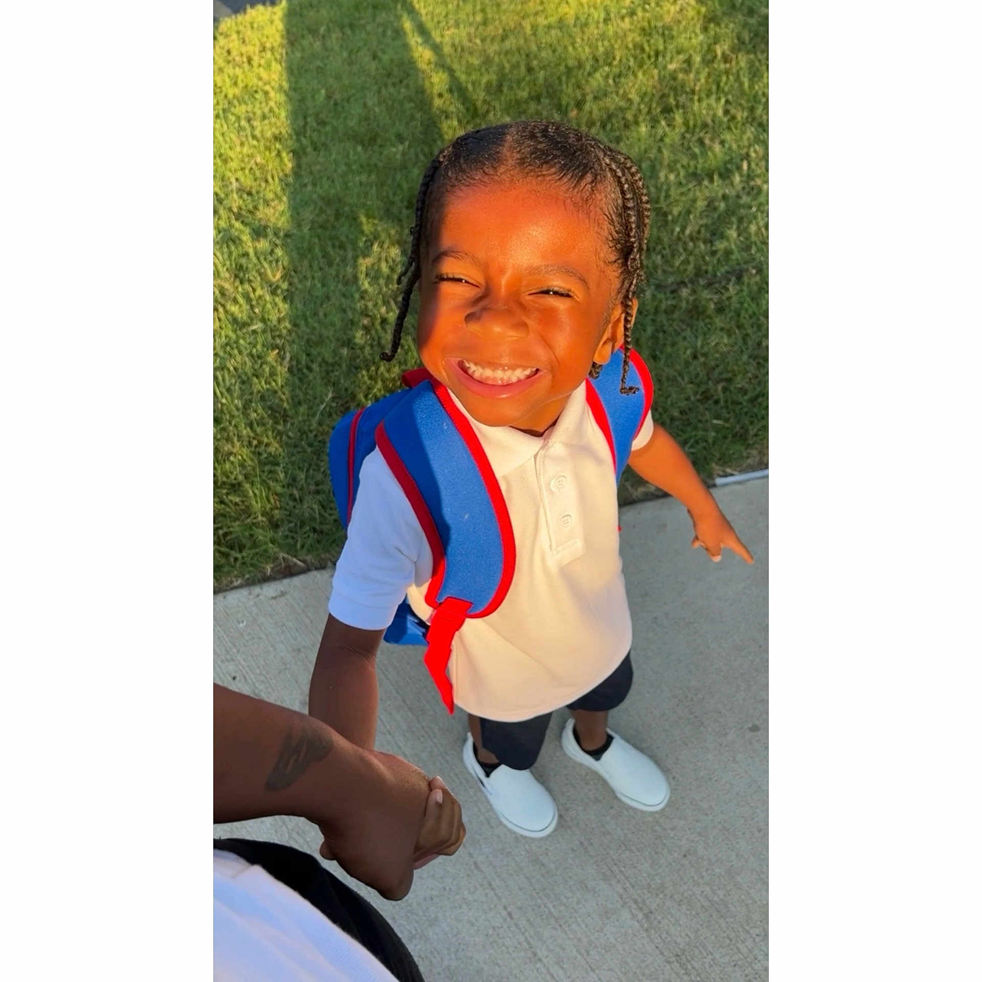 Tyler is registered to the contest to win money with this photo: adult, child, clothing, face, female, footwear, girl, grass, happy, head, male, man, person, photography, plant, portrait, shoe, sitting, smile, vest