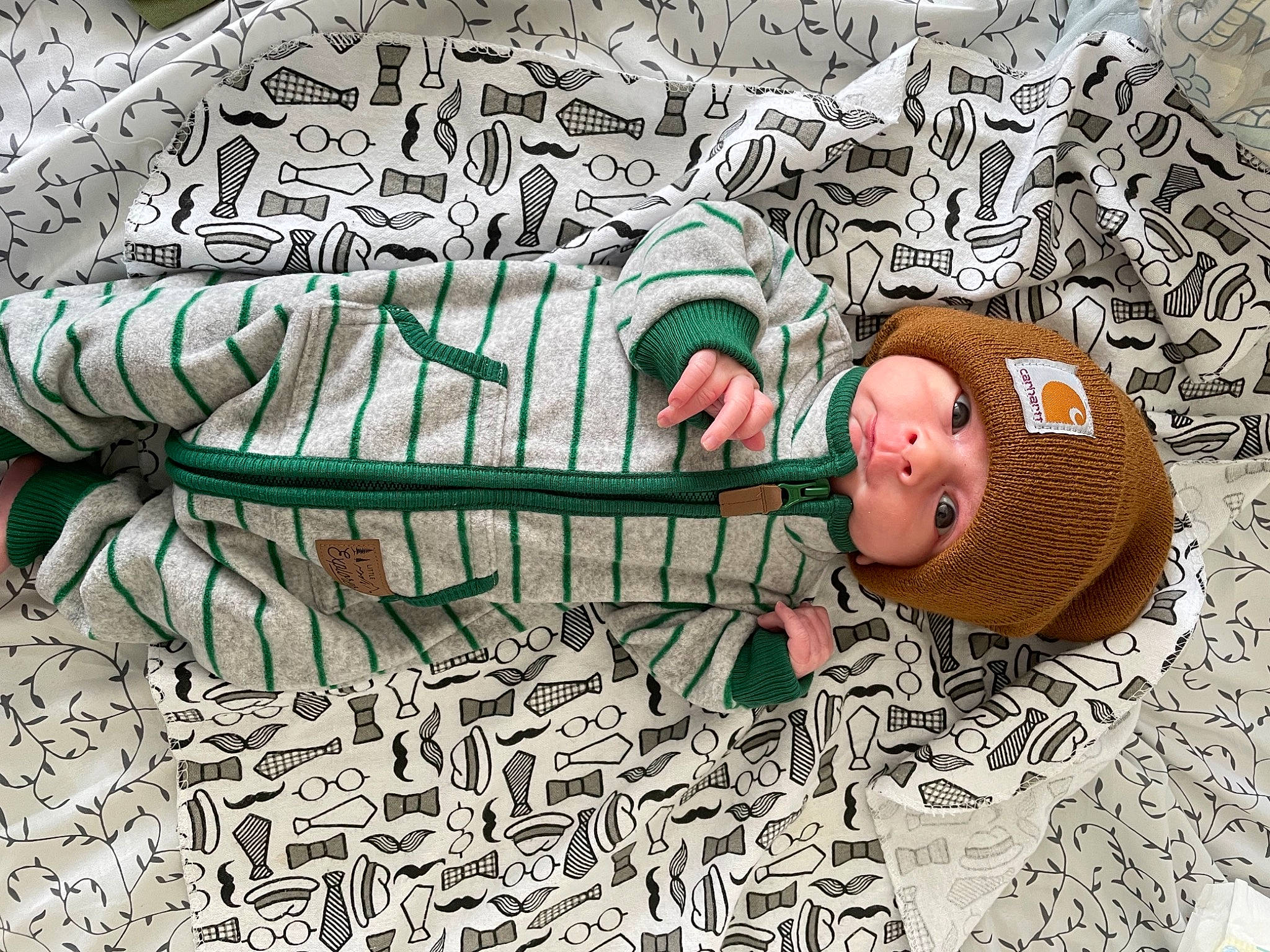 Benton is registered to the contest to win money with this photo: art, baby, comfort, grass, grass_family, headwear, human, human_body, illustration, linens, mammal, organism, pattern, people_in_nature, person, sitting, textile, toddler, tree, twig