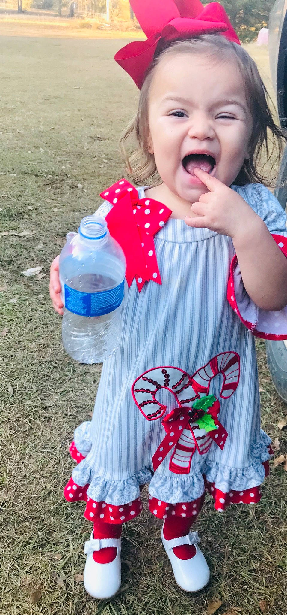 Emmalee joined the competition — help win amazing prizes! baby_toddler_clothing, bottle, child, clothing, event, fun, grass, green, happy, organ, pattern, people_in_nature, person, photograph, pink, plastic_bottle, red, sleeve, summer, toddler