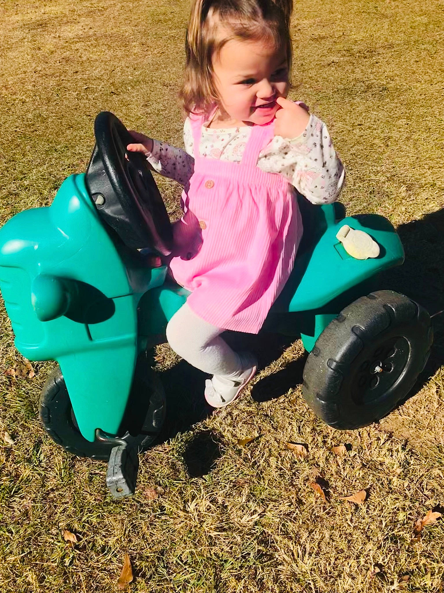 Emmalee joined the competition — help win amazing prizes! baby, baby_products, baby_toddler_clothing, child, city, fun, grass, happy, leisure, people_in_nature, person, pink, play, recreation, riding_toy, shoe, sitting, sneakers, tire, toddler