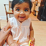 Ayzel joined the competition — help win amazing prizes! baby, child, smiling, indoor, toy, hand, furniture, kitchen, person, happy, sitting, clothing, pants, top, floor, wooden_floor, chair, appliance, support, cute