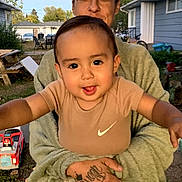 Tre'Von Gibbons Jr is registered to the contest to win money with this photo: toddler, child, person, smiling, outdoor, toy, backyard, picnic_table, clothing, face, adult, hand, grass, house, fence, sunset, casual, playful, happy, portrait