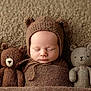 adorable, baby, bear_ears, brown_blanket, child, closeup, cozy, cute, infant, knitted_hat, knitted_toys, knitwear, newborn, portrait, resting, sleep, sleeping, soft_texture, stuffed_animals, warm_colors