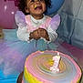 child, toddler, birthday_cake, cake, candle, balloons, tutu, pastel_colors, frosting, messy_face, smile, celebration, party, dress, first_birthday, portrait, tablecloth, pink, blue, joy