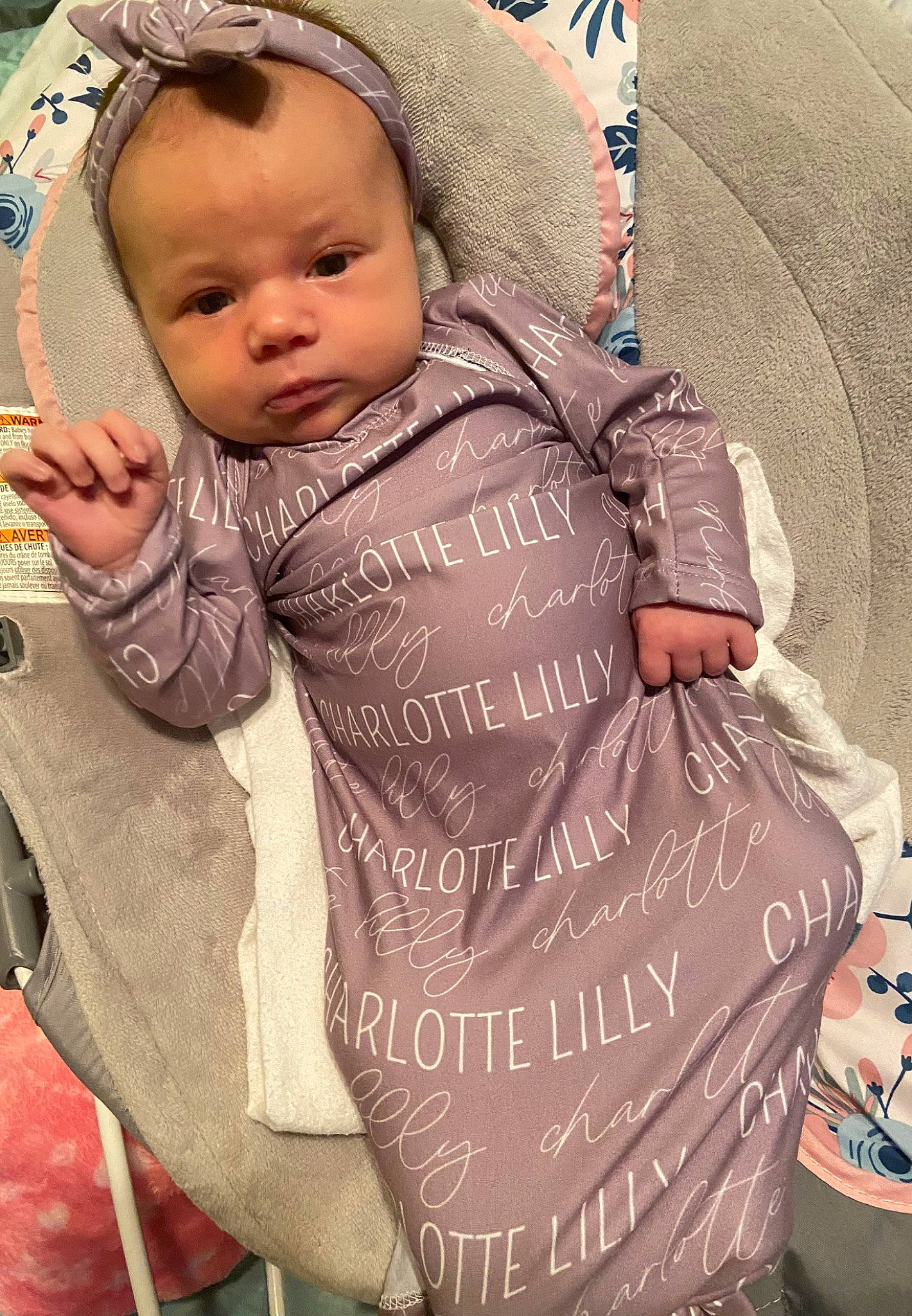 Charlotte is registered to the contest to win money with this photo: baby, baby_carriage, baby_products, baby_safety, baby_toddler_clothing, bib, cap, cheek, child, comfort, fashion_accessory, happy, hood, outerwear, person, personal_protective_equipment, pink, sitting, skin, sleeve