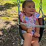 Kennedy joined the competition — help win amazing prizes! toddler, child, swing, outdoor, playground, grass, sunlight, dress, sandals, happy, smile, park, trees, metal_chain, seat, nature, daytime, person, young_child, casual_clothing