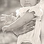 Kennedy joined the competition — help win amazing prizes! baby, child, bow, headband, hand, adult_hand, outdoor, monochrome, black_and_white, portrait, cute, infant, dress, person, skin, earring, expression, holding, soft_light, young