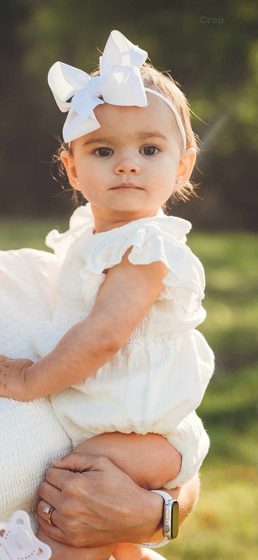 Kennedy joined the competition — help win amazing prizes! toddler, child, white_clothing, headband, bow, baby, portrait, outdoor, nature, greenery, hand, watch, ring, cute, young, innocent, soft_light, summer, person, holding