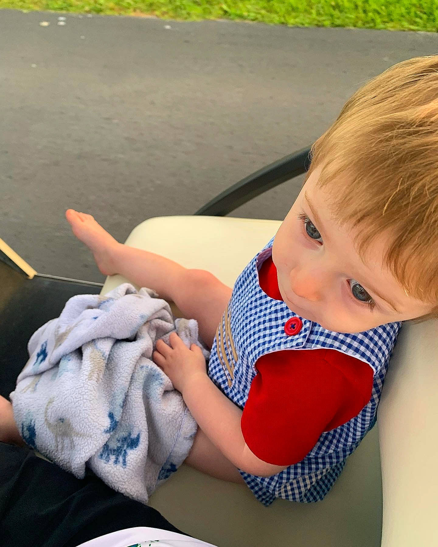 Theodore is registered to the contest to win money with this photo: baby, baby_products, baby_toddler_clothing, carmine, child, electric_blue, finger, fun, grass, happy, human_leg, leisure, pattern, person, recreation, sitting, summer, textile, thigh, toddler