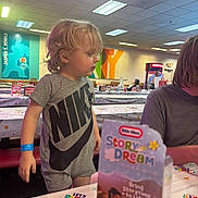 Axton joined the competition — help win amazing prizes! birthday, blond_hair, celebration, child, colorful, decor, event, face, indoor, nike, party, people, person, restaurant, seated, shirt, shorts, table, tablecloth, toddler