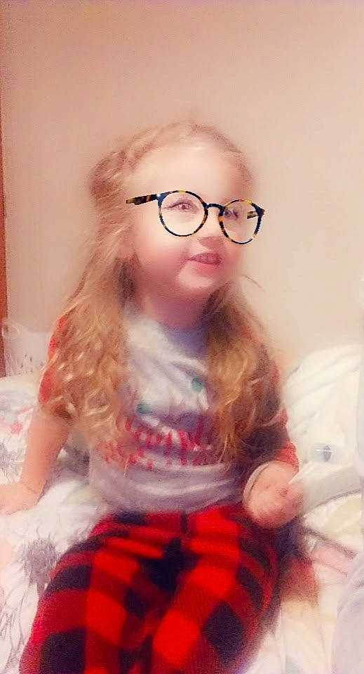 Dalylah is registered to the contest to win money with this photo: baby_toddler_clothing, cheek, eye, eyelash, eyewear, face, gesture, glasses, hair, happy, head, iris, lip, nose, person, pink, plaid, skin, sleeve, tartan