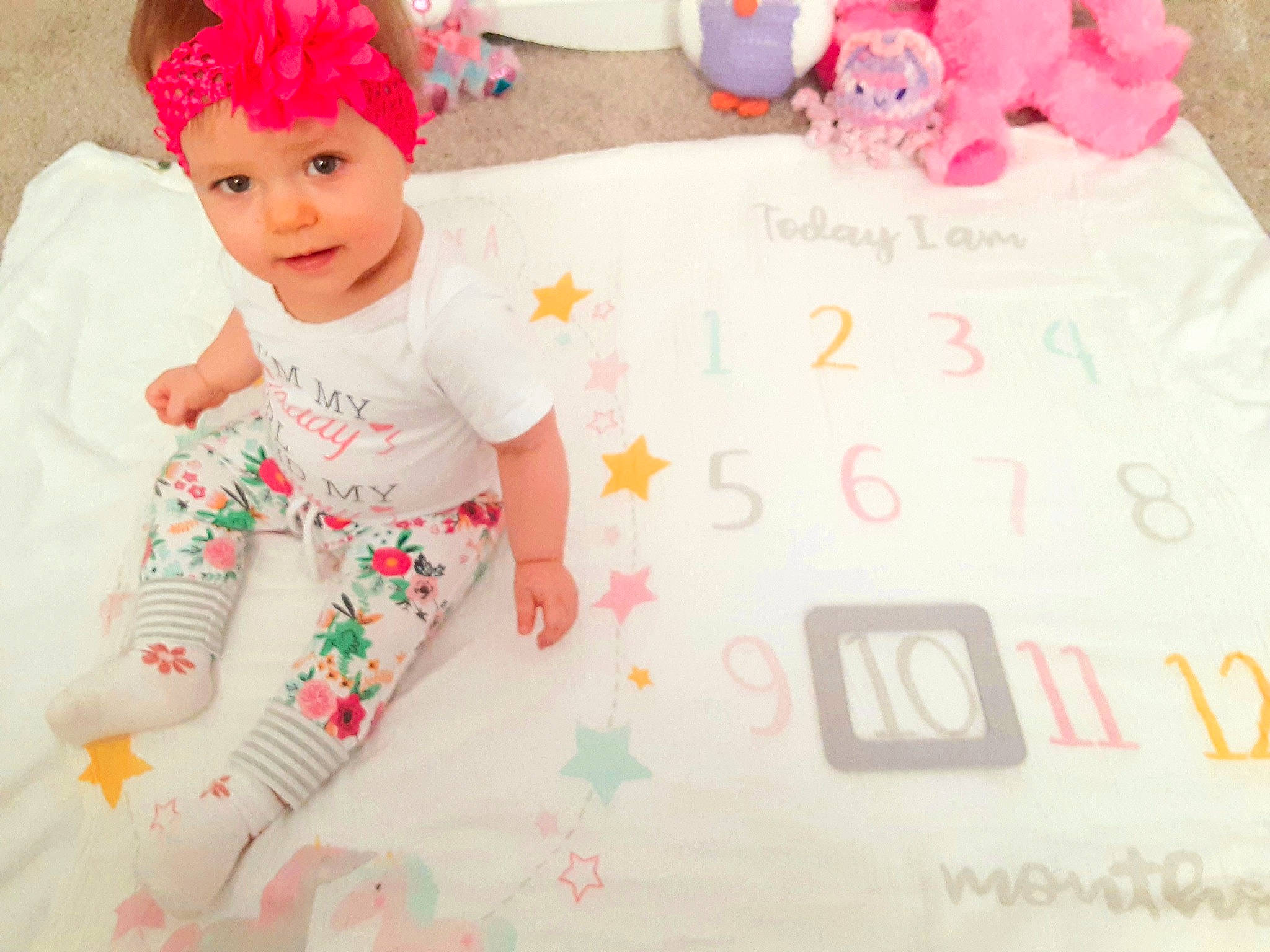 Maizie is registered to the contest to win money with this photo: baby, baby_toddler_clothing, cap, child, costume_hat, font, fun, happy, headband, headpiece, headwear, linens, magenta, pattern, person, pink, play, sleeve, smile, t_shirt