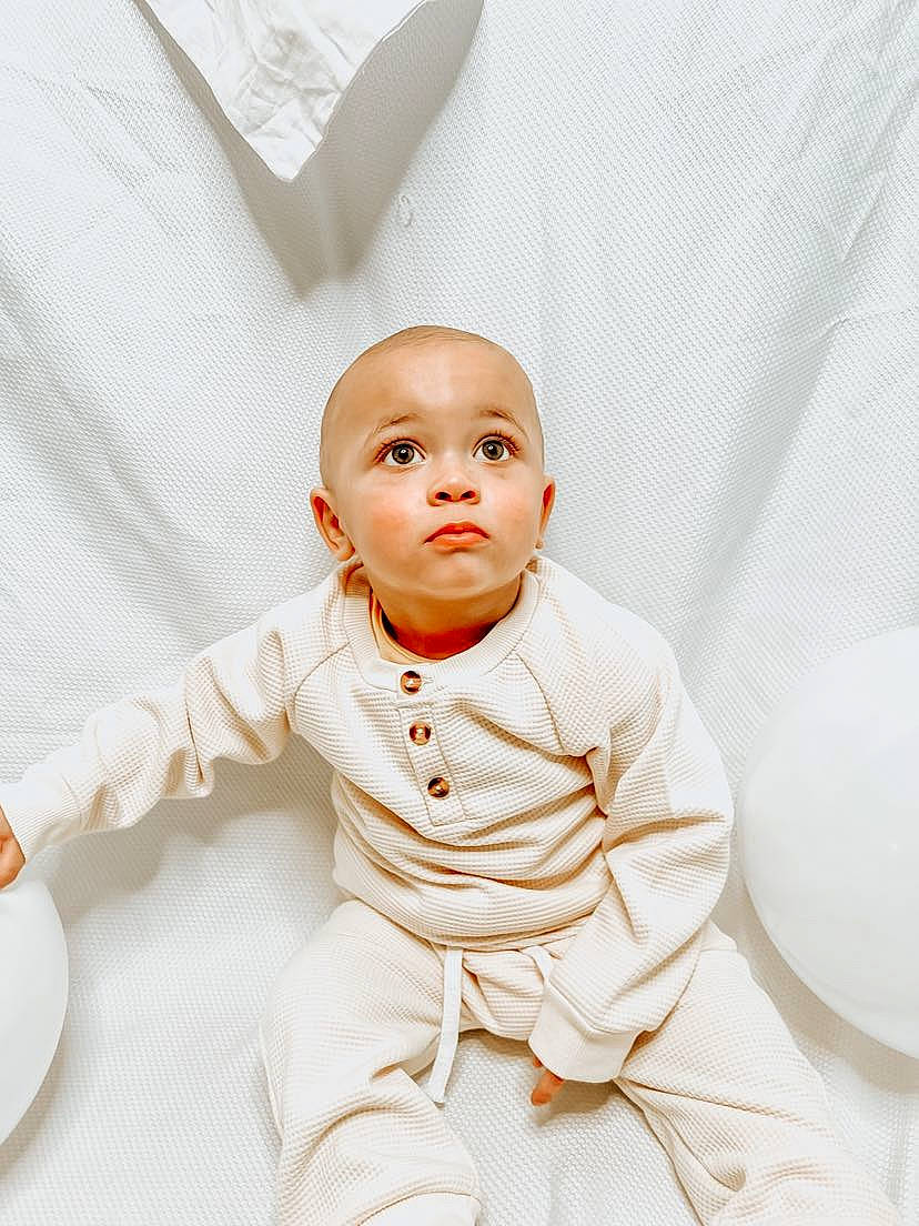 Dallis is registered to the contest to win money with this photo: art, baby, baby_toddler_clothing, child, collar, comfort, dress_shirt, eye, fashion_accessory, flash_photography, formal_wear, gesture, happy, head, human_body, linens, neck, person, sitting, sleeve