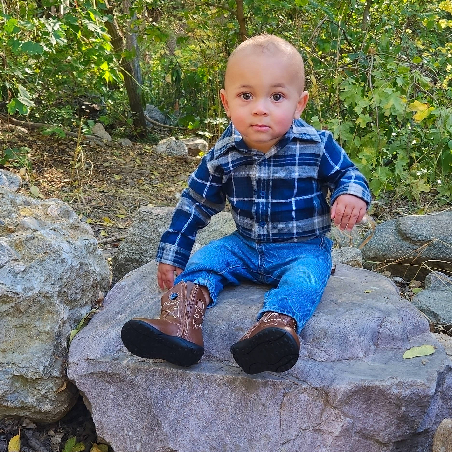 Dallis is registered to the contest to win money with this photo: baby_toddler_clothing, bedrock, child, denim, electric_blue, garden, grass, landscape, leisure, pattern, people_in_nature, person, plaid, plant, rock, sitting, sleeve, soil, tartan, toddler