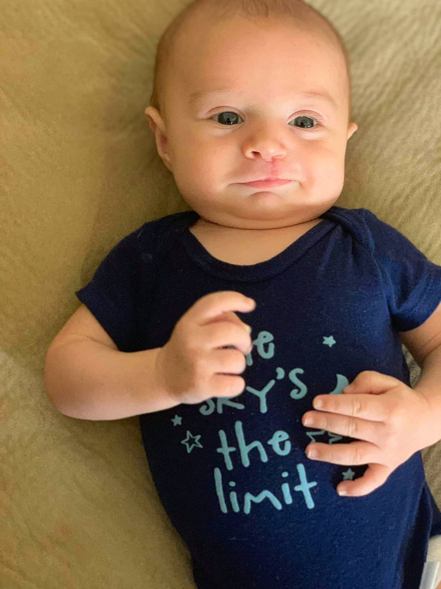 Brenton is registered to the contest to win money with this photo: arm, baby, baby_products, baby_toddler_clothing, cheek, child, face, finger, hand, head, neck, person, product, skin, sleeve, smile, standing, t_shirt, toddler