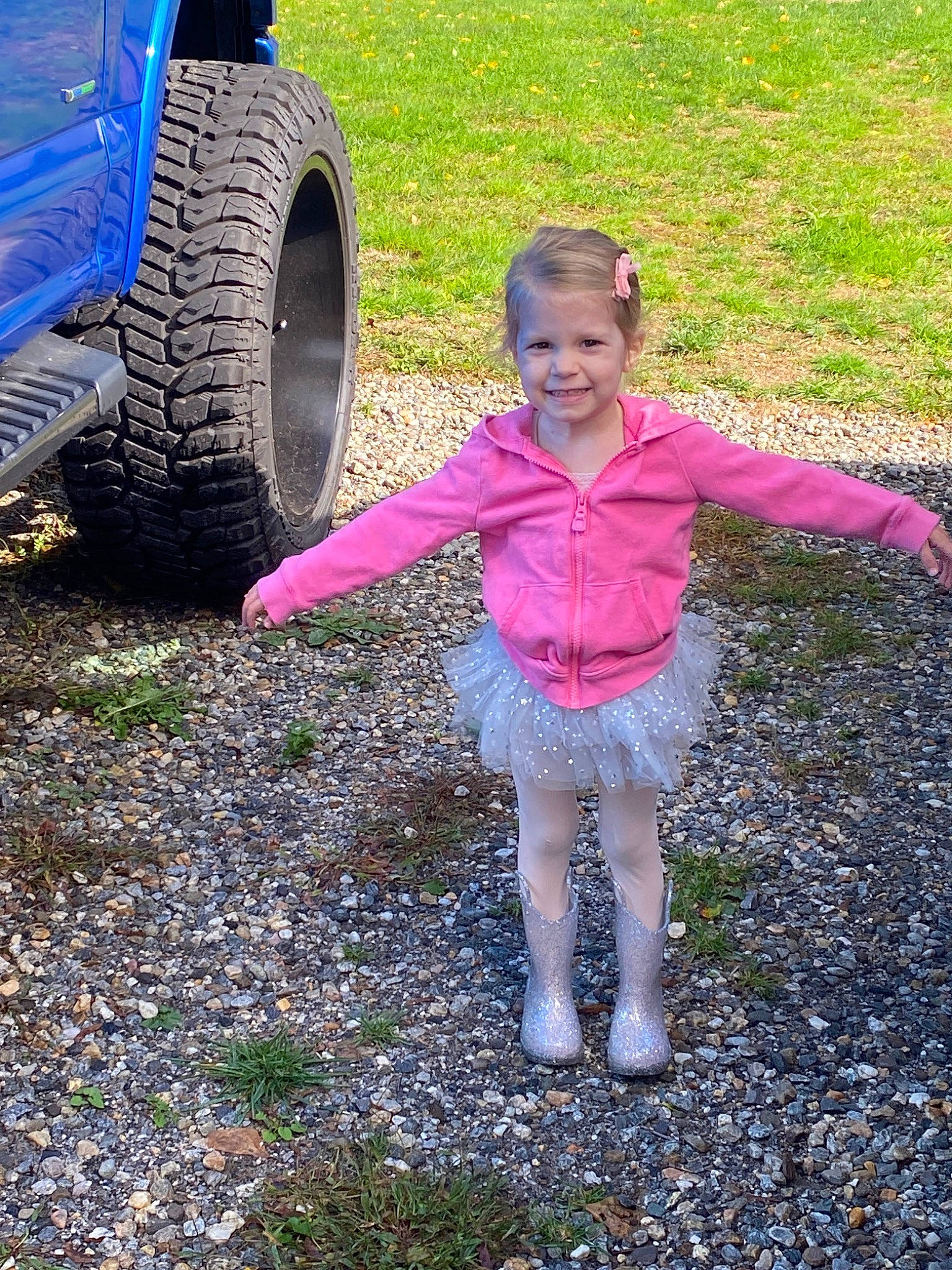 Talia joined the competition — help win amazing prizes! alloy_wheel, asphalt, automotive_tire, bumper, fender, grass, happy, joy, leaf, leisure, motor_vehicle, people_in_nature, person, rim, road_surface, rolling, smile, synthetic_rubber, tire, tire_care