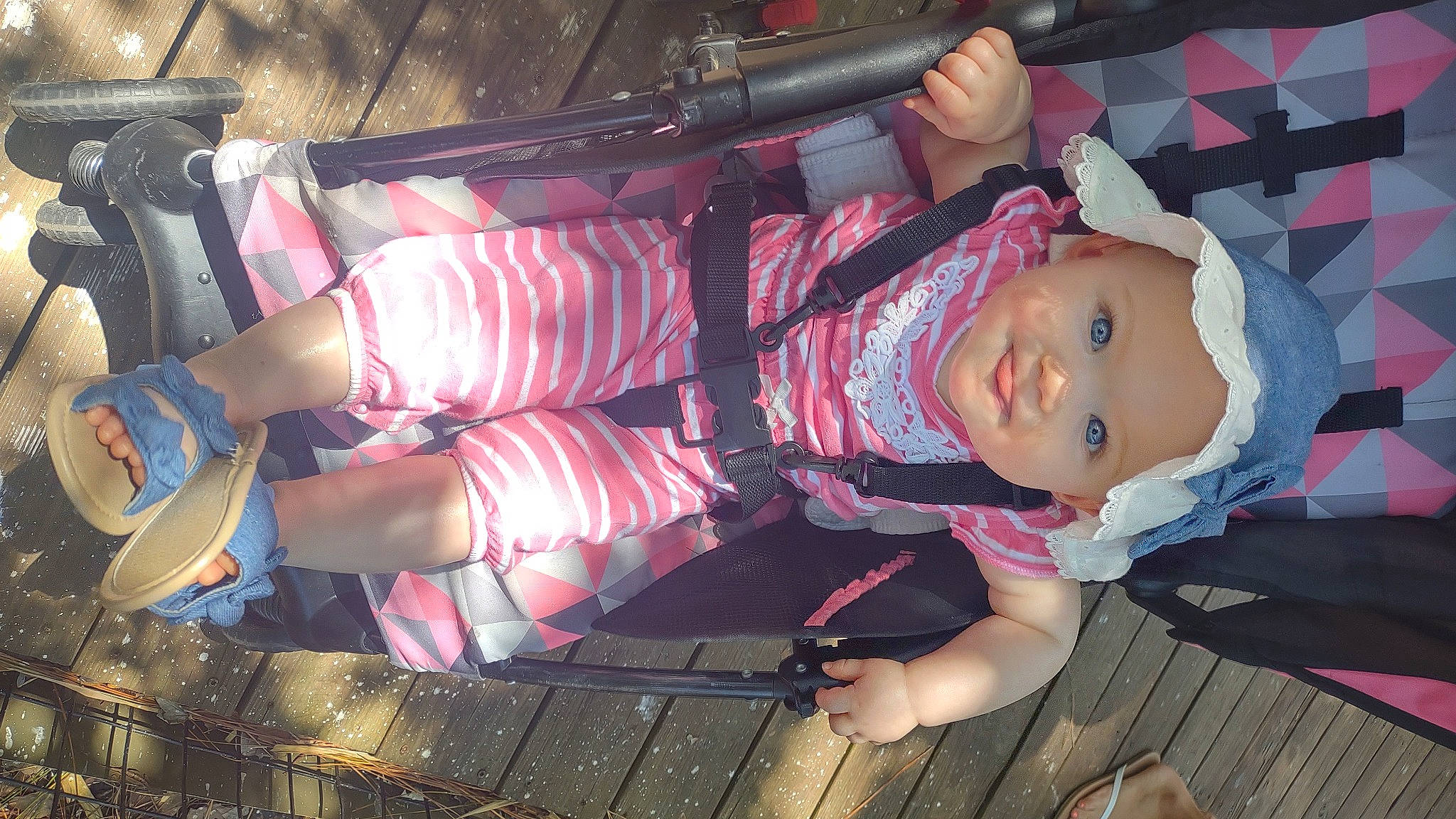 Josephine is registered to the contest to win money with this photo: baby, baby_products, baby_toddler_clothing, child, costume, fun, headwear, human_leg, knee, lap, magenta, pattern, person, pink, plaid, sandal, sitting, sock, tartan, thigh