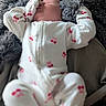 Anya is registered to the contest to win money with this photo: baby, sleeping, onesie, cherry_print, blanket, gray, soft, cozy, infant, child, cute, resting, clothing, furniture, portrait, indoor, relaxed, comfort, head, face