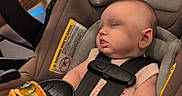 Anya joined the competition — help win amazing prizes! baby, sleeping, car_seat, taco, food, restaurant, table, chair, straps, infant, cute, meal, indoor, person, head, clothing, seat, peaceful, hand, caption