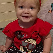 Blakley joined the competition — help win amazing prizes! baby, child, smiling, headband, bow, red_shirt, cartoon_character, heart_shaped_glasses, polka_dot_leggings, white_socks, frills, indoor, bed, blanket, cute, happy, person, portrait, infant, clothing