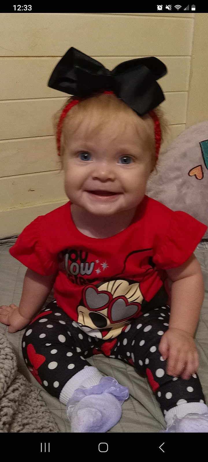 Blakley joined the competition — help win amazing prizes! baby, child, smiling, headband, bow, red_shirt, cartoon_character, heart_shaped_glasses, polka_dot_leggings, white_socks, frills, indoor, bed, blanket, cute, happy, person, portrait, infant, clothing