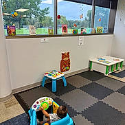Elijah A Lawson is registered to the contest to win money with this photo: books, child, children, colorful, decorations, educational, floor, fun, furniture, greenery, happy, indoor, learning, play_mat, playroom, reading, sunlight, toddler, toy_car, window