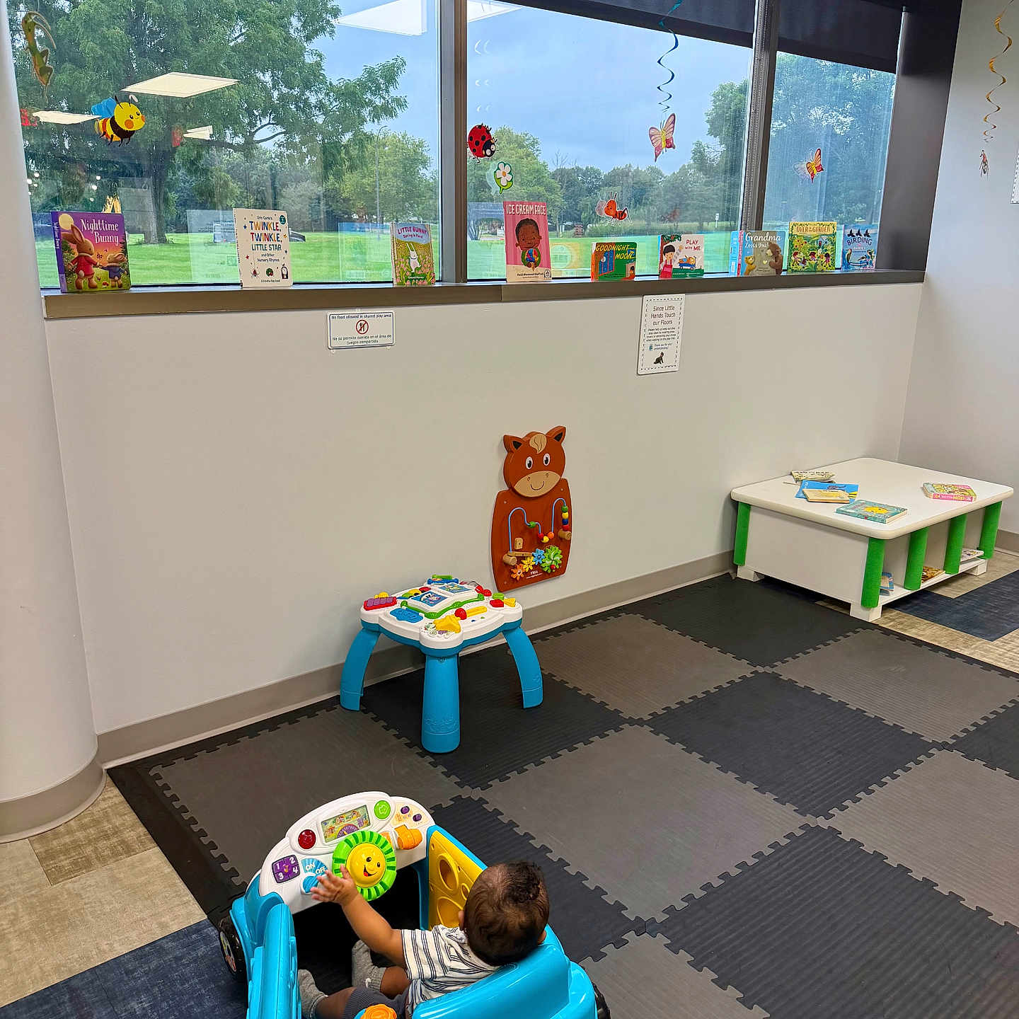 Elijah A Lawson is registered to the contest to win money with this photo: books, child, children, colorful, decorations, educational, floor, fun, furniture, greenery, happy, indoor, learning, play_mat, playroom, reading, sunlight, toddler, toy_car, window