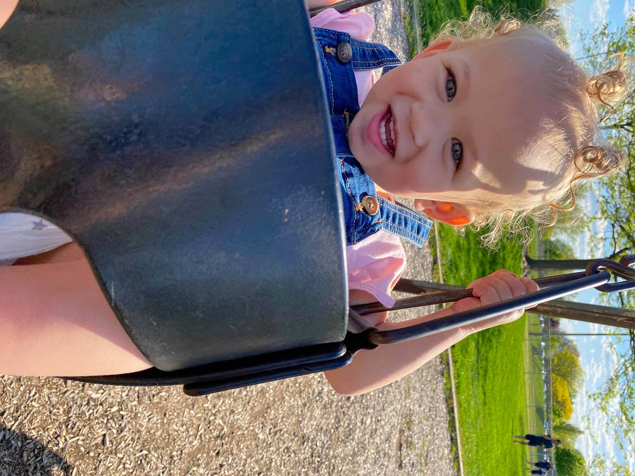 Kamila is registered to the contest to win money with this photo: automotive_exterior, baby, child, fun, grass, happy, human_body, leisure, person, personal_protective_equipment, plant, recreation, shade, smile, sunlight, toddler, tree, vehicle_door, window, windshield