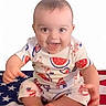 Colter is registered to the contest to win money with this photo: baby, child, smiling, sitting, american_flag, clothing, watermelon_pattern, popsicle_pattern, cute, happy, indoors, infant, portrait, feet, hands, head, eyes, mouth, short_hair, playful