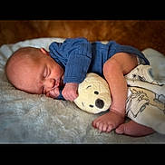 Sawyer joined the competition — help win amazing prizes! baby, newborn, sleeping, plush_toy, blanket, blue_clothing, infant, peaceful, soft_texture, cute, cozy, child, portrait, resting, indoors, human, small, toddler, sleep, cuddle