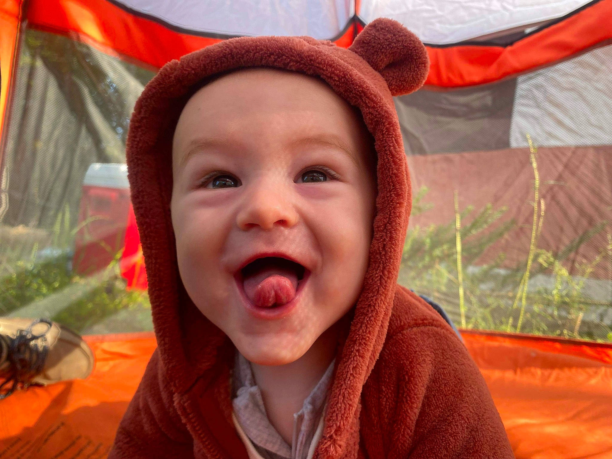 Valen is registered to the contest to win money with this photo: baby_laughing, event, fun, grass, happy, hat, headwear, iris, leisure, lip, mouth, nose, organ, people, person, plant, red, smile, toddler, tooth