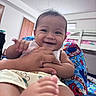 baby, smile, hand, foot, indoor, bedroom, bunk_bed, clothing, person, child, colorful, sesame_street, furniture, blanket, happy, cute, portrait, playful, young, holding