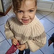 Savannah participe au concours pour gagner de l'argent avec cette photo : bag, boots, casual_clothing, child, curly_hair, cute, dog, door, floor, happy, home, indoor, knitted, person, portrait, smile, sweater, tiled_floor, window, young_child
