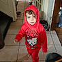 barefoot, bucket, child, curious, curly_hair, dog_food_bag, door, face, hello_kitty, hoodie, indoor, kitchen, mop, person, plastic_toy, red_clothing, shoes, standing, tile_floor, toddler