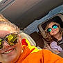 Ophelia-Rayne is registered to the contest to win money with this photo: adult, child, car, sunglasses, smile, seatbelt, hoodie, window, sunlight, reflection, backseat, portrait, happy, casual, interior, roadtrip, person, daytime, glasses, fun