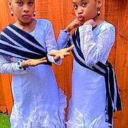 Arianna And Brianna joined the competition — help win amazing prizes! child, girl, twins, matching_outfits, white_dress, black_and_white_sash, hairstyle, hair_accessories, earrings, posing, outdoor, grass, wooden_fence, footwear, golden_sandals, fashion, portrait, smiling, cute, playful