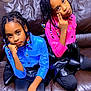 Arianna And Brianna is registered to the contest to win money with this photo: child, girl, braided_hair, beads, blue_shirt, pink_shirt, black_skirt, leggings, brown_couch, indoor, pose, expression, sitting, furniture, person, portrait, fashion, cute, colorful, hair_accessories