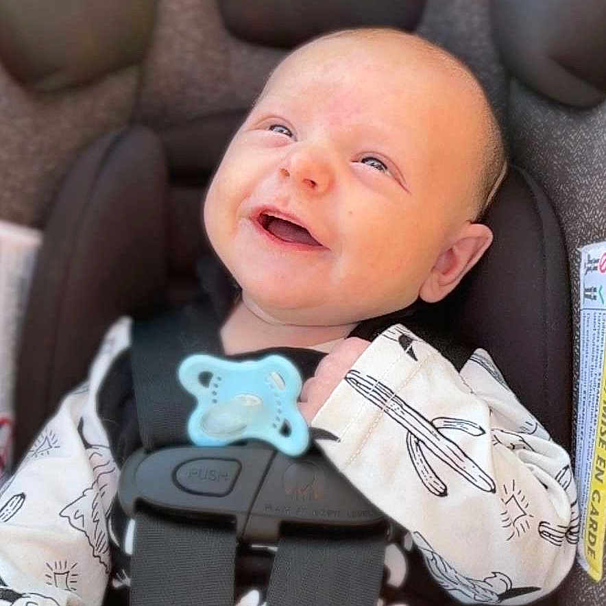 Rustyn is registered to the contest to win money with this photo: baby, clothing, coat, cushion, face, glove, gun, happy, head, homedecor, jacket, newborn, person, photography, portrait, sleeping, stroller, transportation, vehicle, weapon